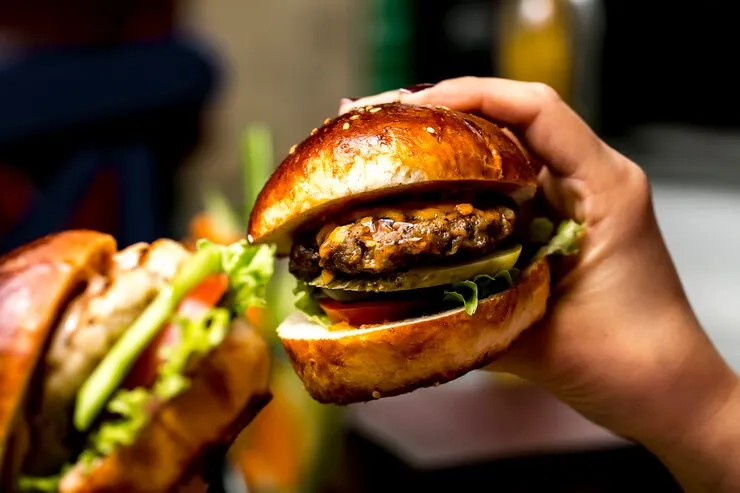 man-holds-meat-burger